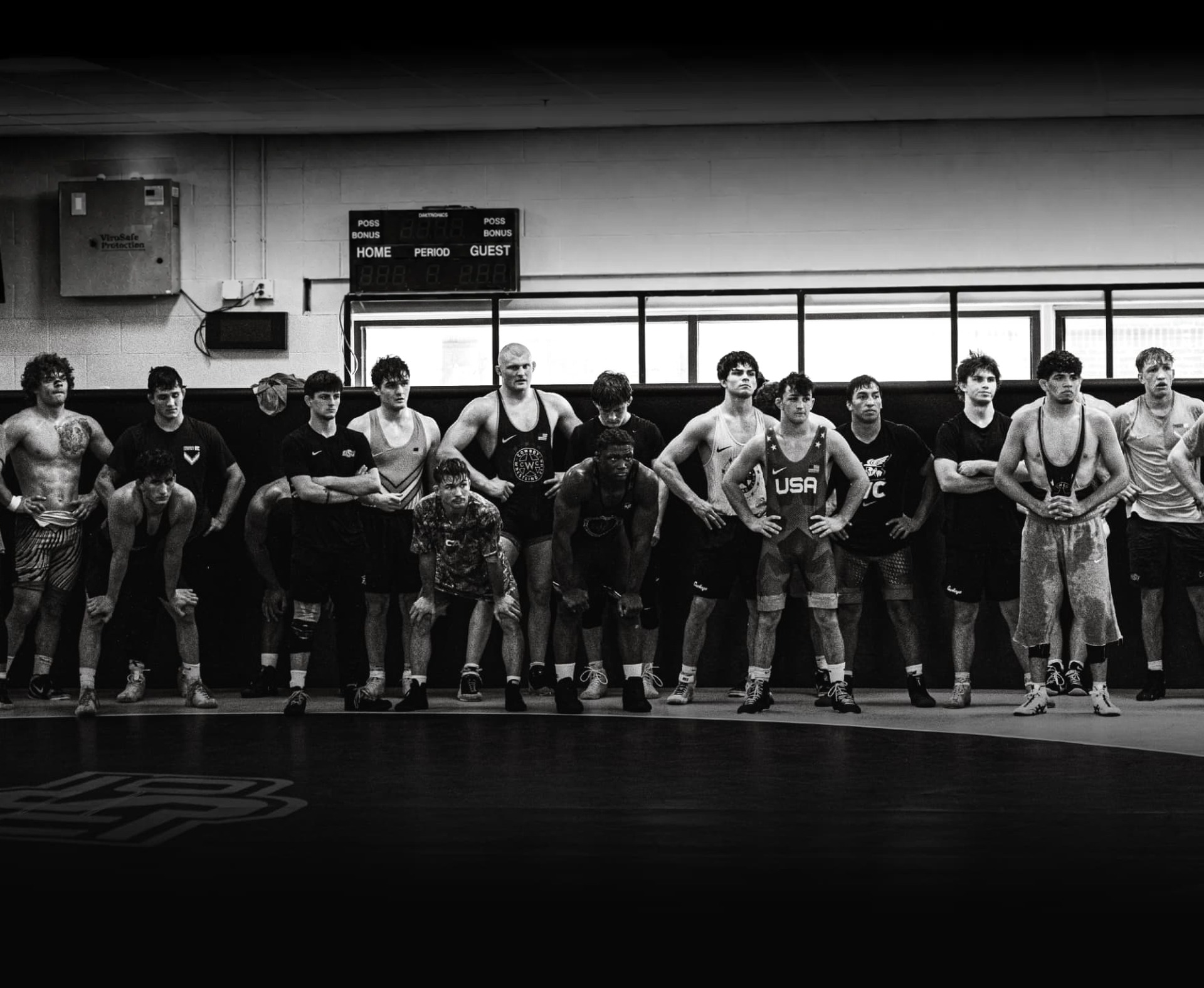 Oklahoma State wrestlers lined up beside the wrestling mat